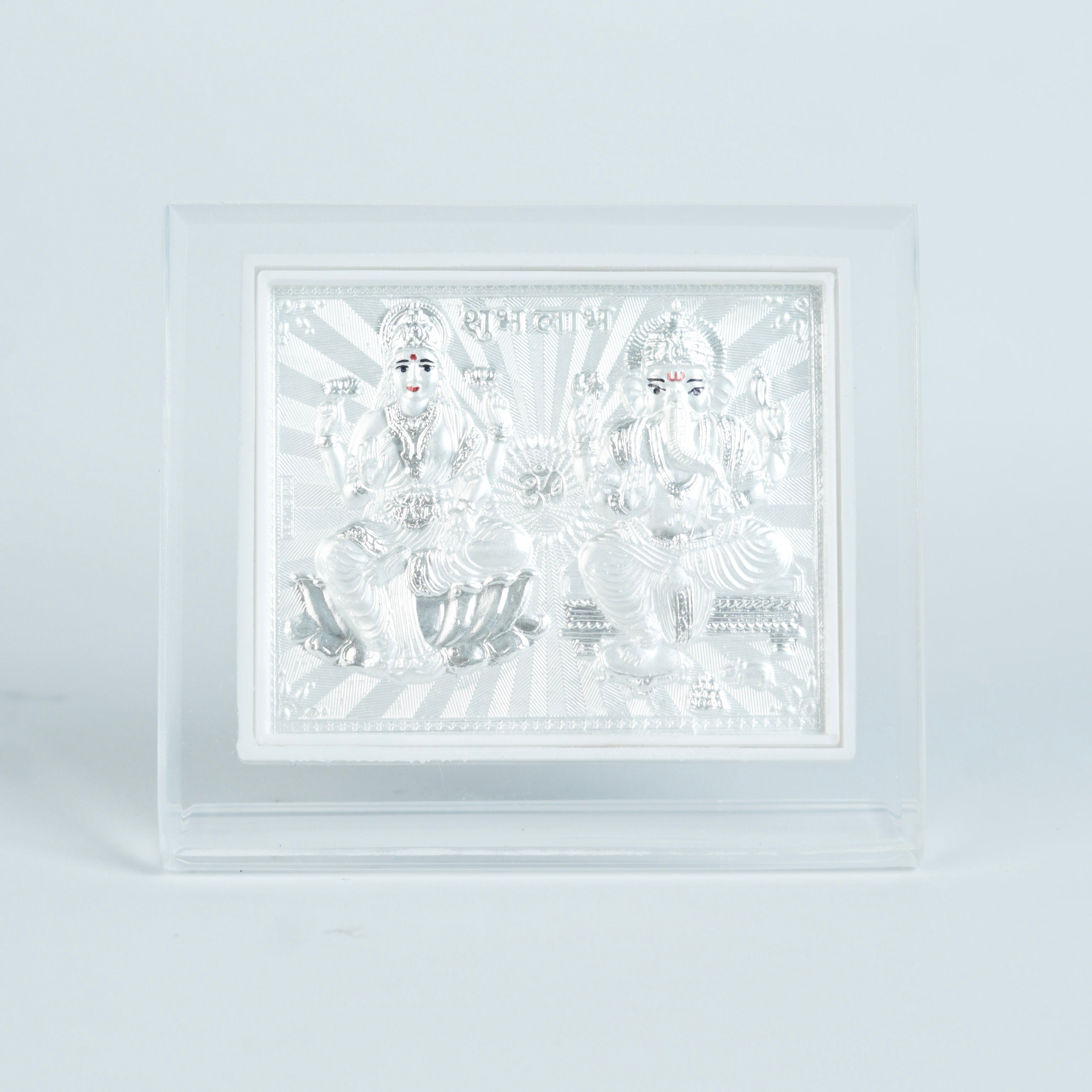 Close-up of silver Lakshmi Ganesh religious wall frame