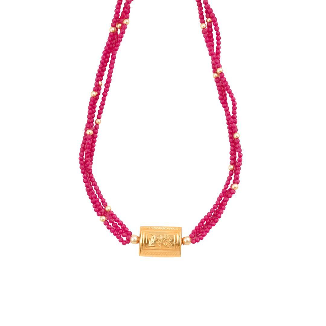 Pink beaded necklace with gold clasp and carved centerpiece