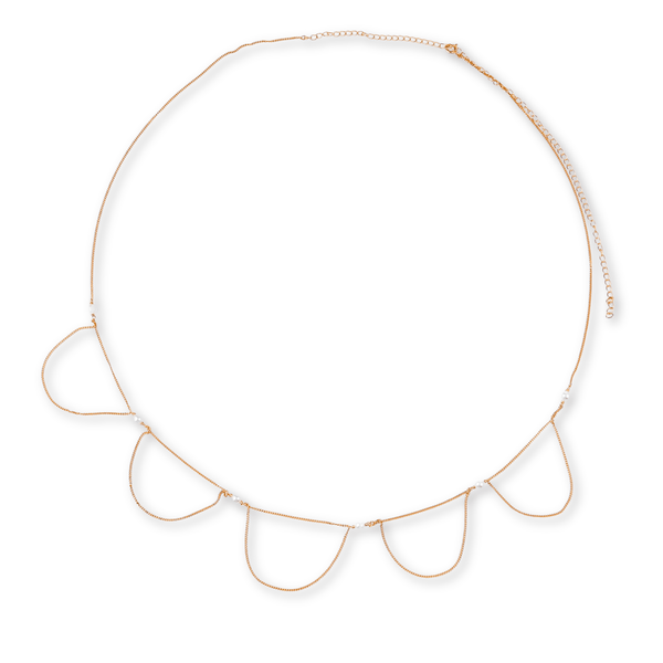 Close-up of gold chain with pearl details for waist jewelry