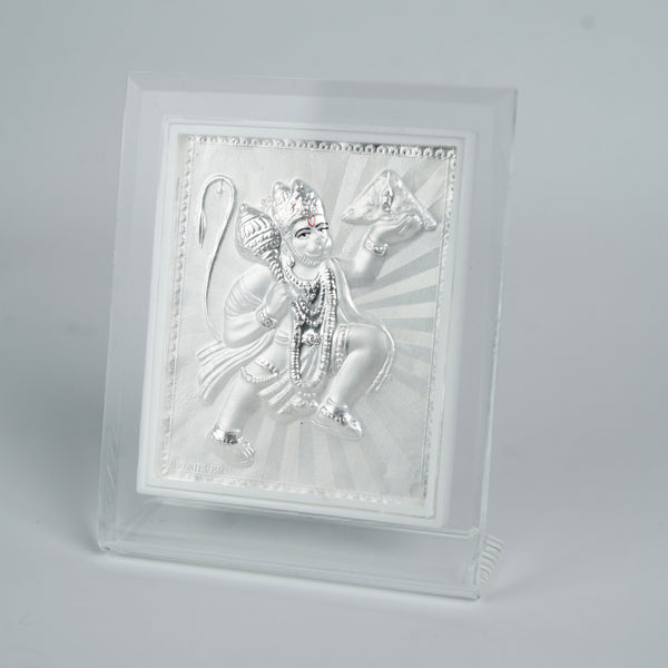 Close-up of engraved silver Hanuman figure on frame