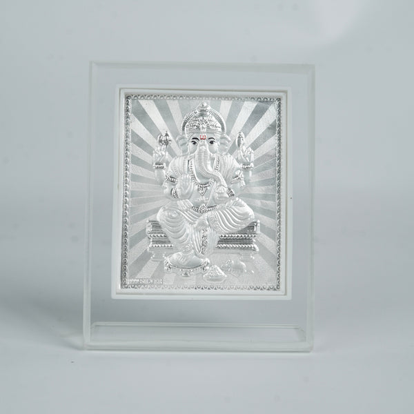 Silver Ganesh deity in white frame for pooja and home decoration