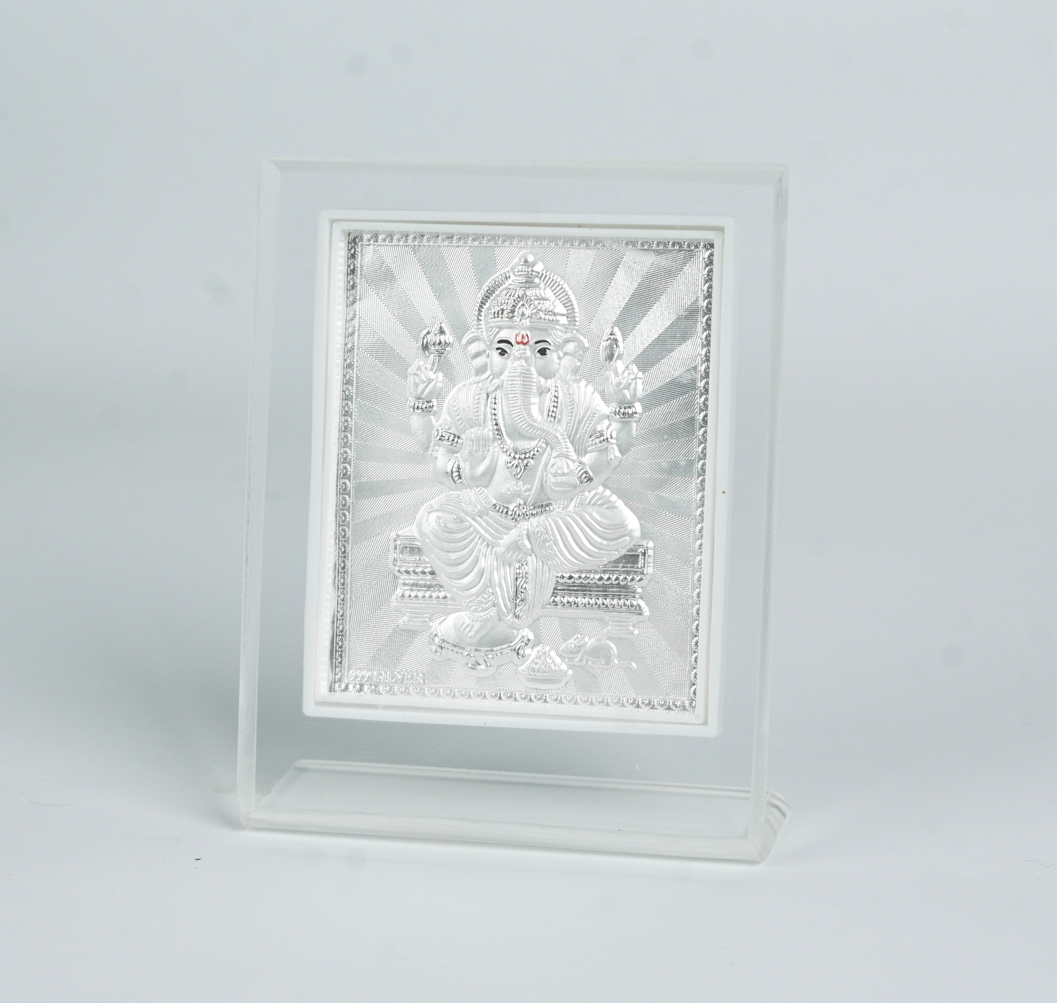 White decorative frame with silver Ganesh idol for auspicious home decor