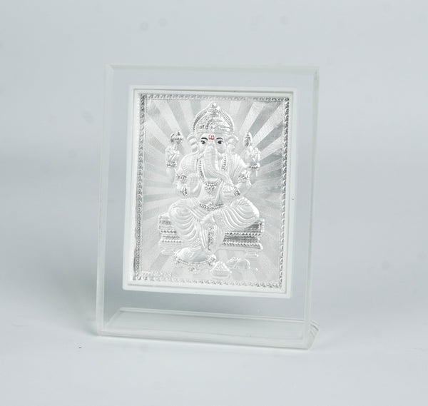 White decorative frame with silver Ganesh idol for auspicious home decor