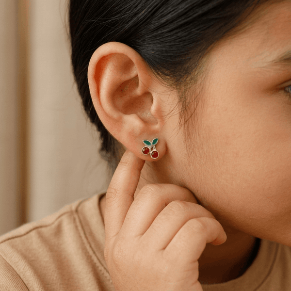 Model wearing cherry enamel earrings in sterling silver