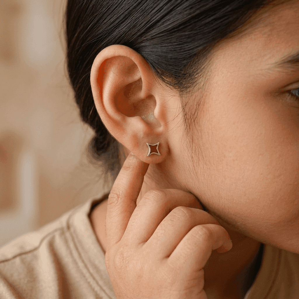 Woman wearing star enamel stud earrings in sterling silver, jewelry accessory