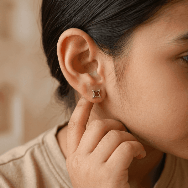 Woman wearing star enamel stud earrings in sterling silver, jewelry accessory