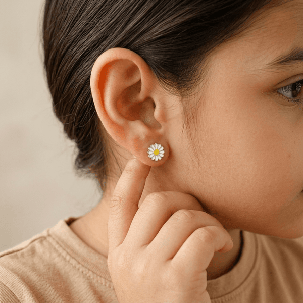 Model wearing daisy enamel stud earrings in sterling silver