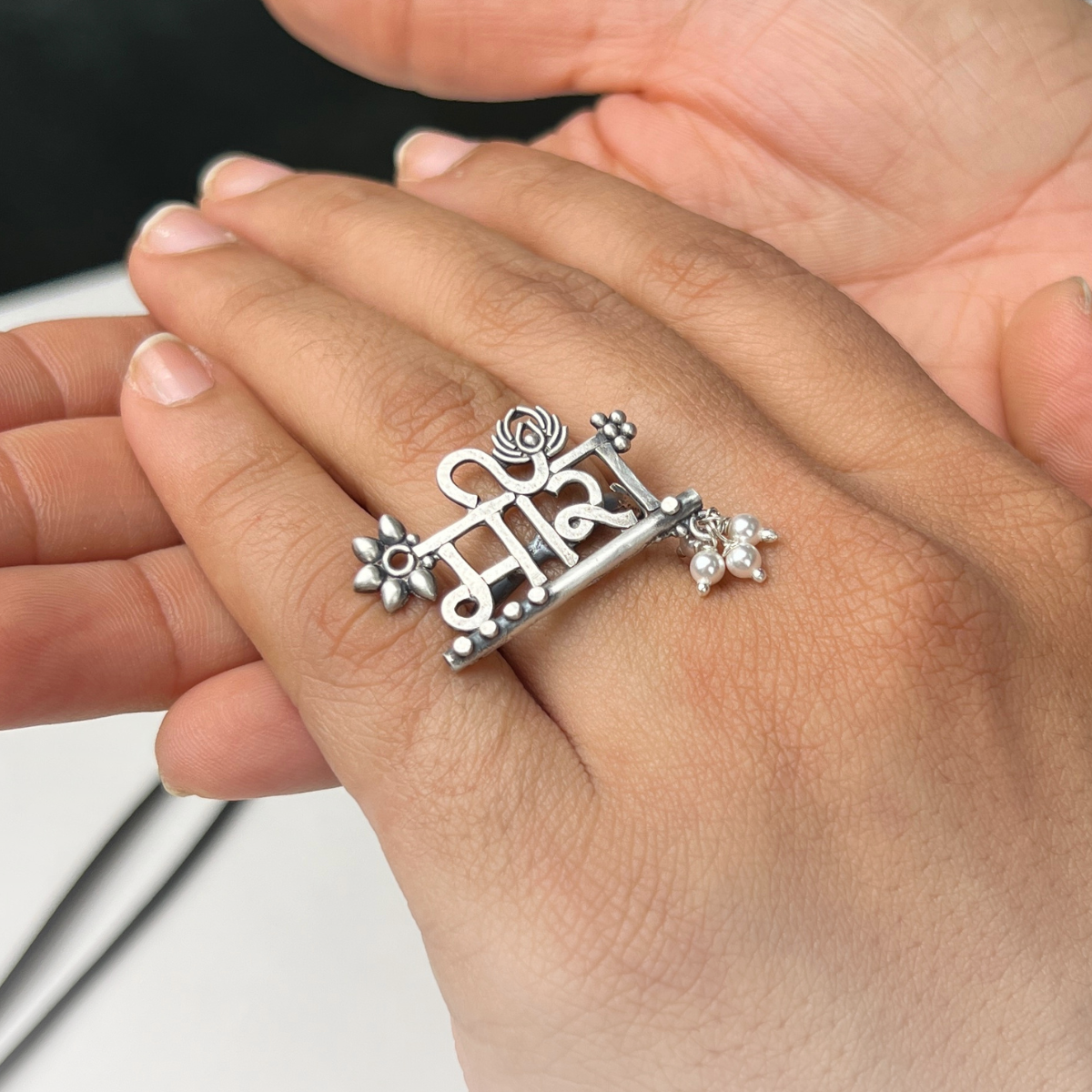 a person wearing a ring with a cross on it