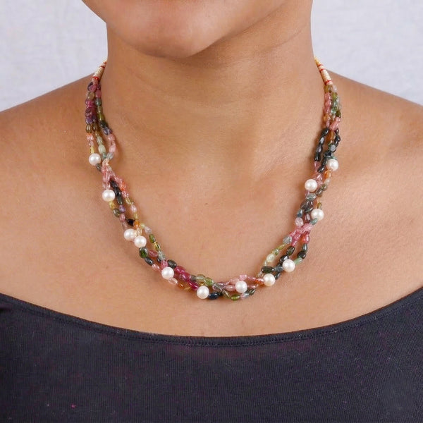 Close-up of beaded necklace with multicolored stones and pearls