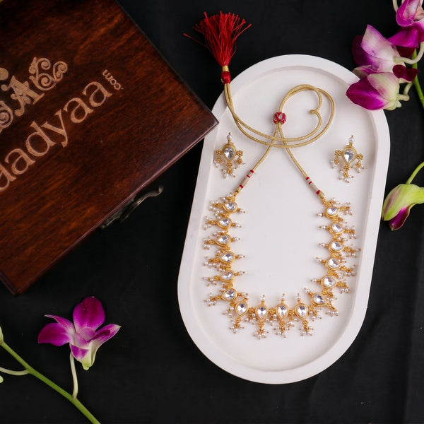 22K gold plated Laffa Tanmani choker with traditional motifs on white display tray