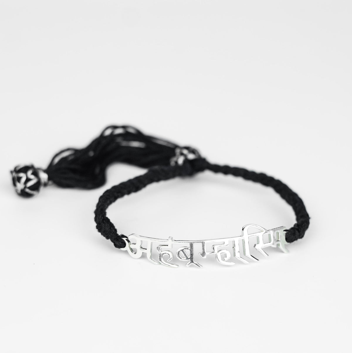 Silver bracelet with Sanskrit inscription on black cord for spiritual jewelry
