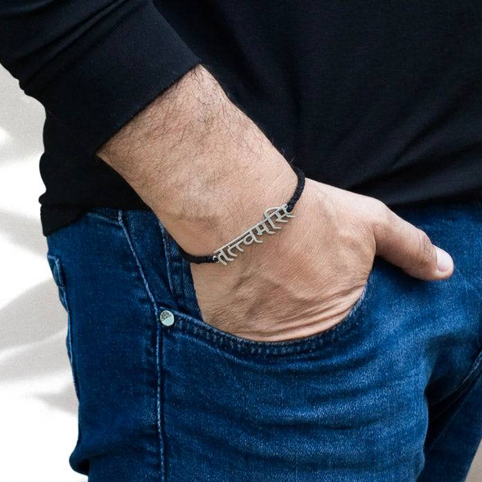 Men's black cord Mahavakya silver bracelet on wrist