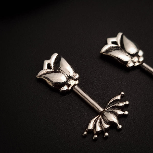 a close up of two metal objects on a black surface