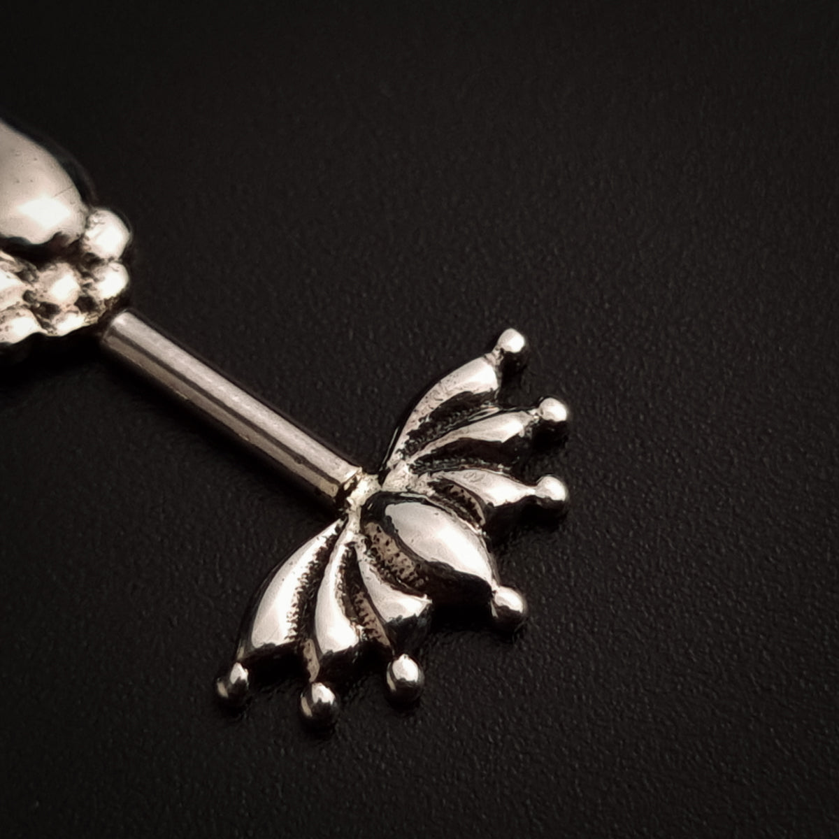 a silver spoon with a flower design on it