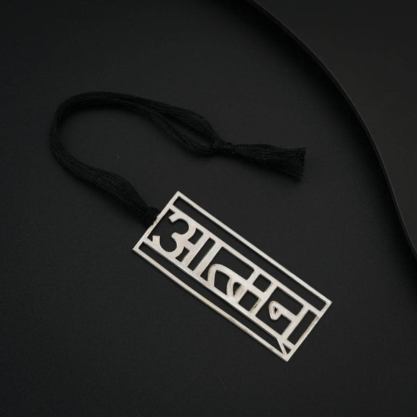 Black tassel with silver 'BADDY' logo tag