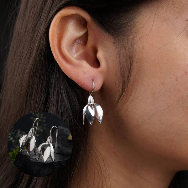 Sterling silver snowflake earrings on ear