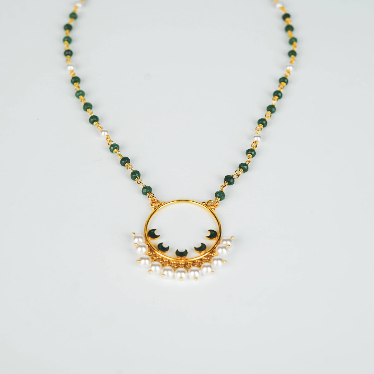 Elegant green and pearl beaded necklace with gold accents, traditional jewelry