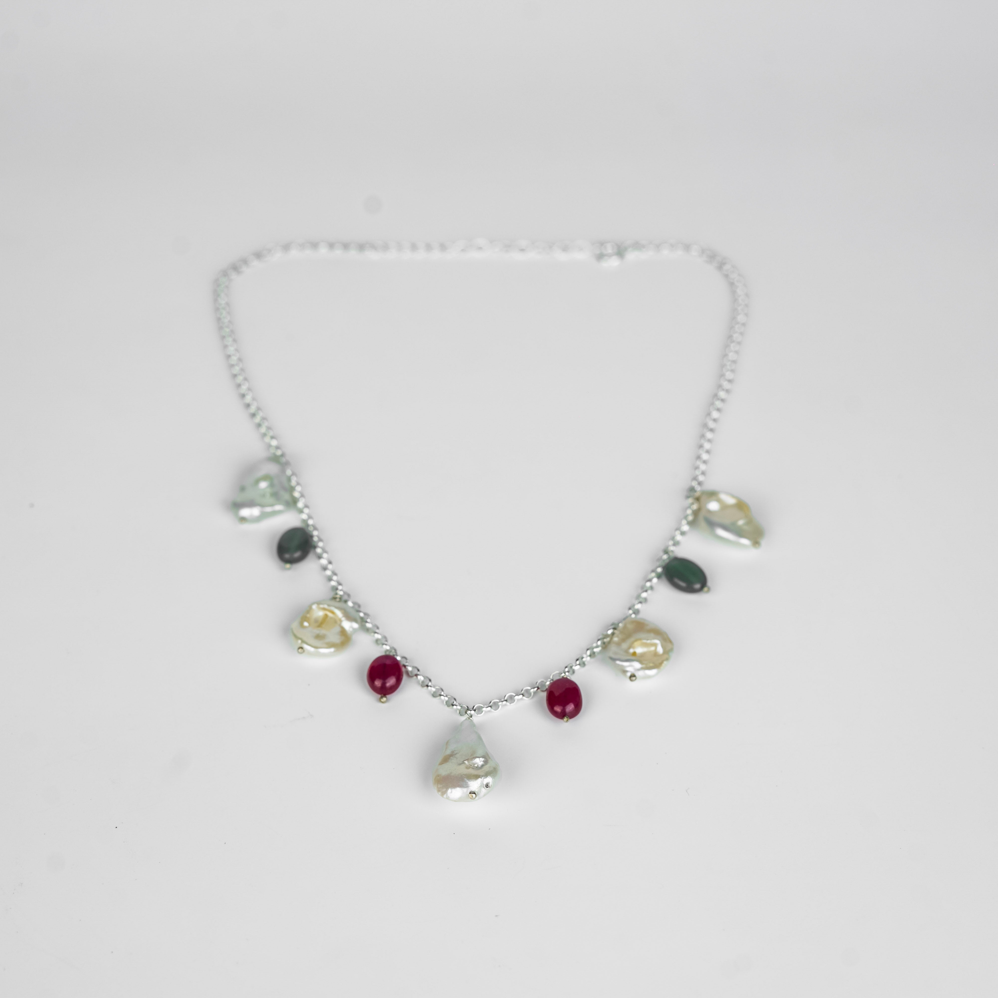 Silver necklace with pearl, ruby, and onyx charms