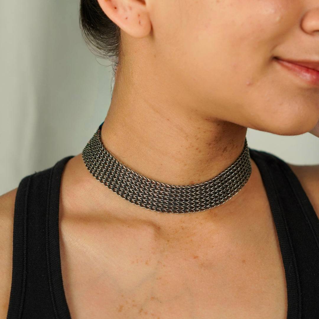 Close-up of silver oxidized tribal motif necklace