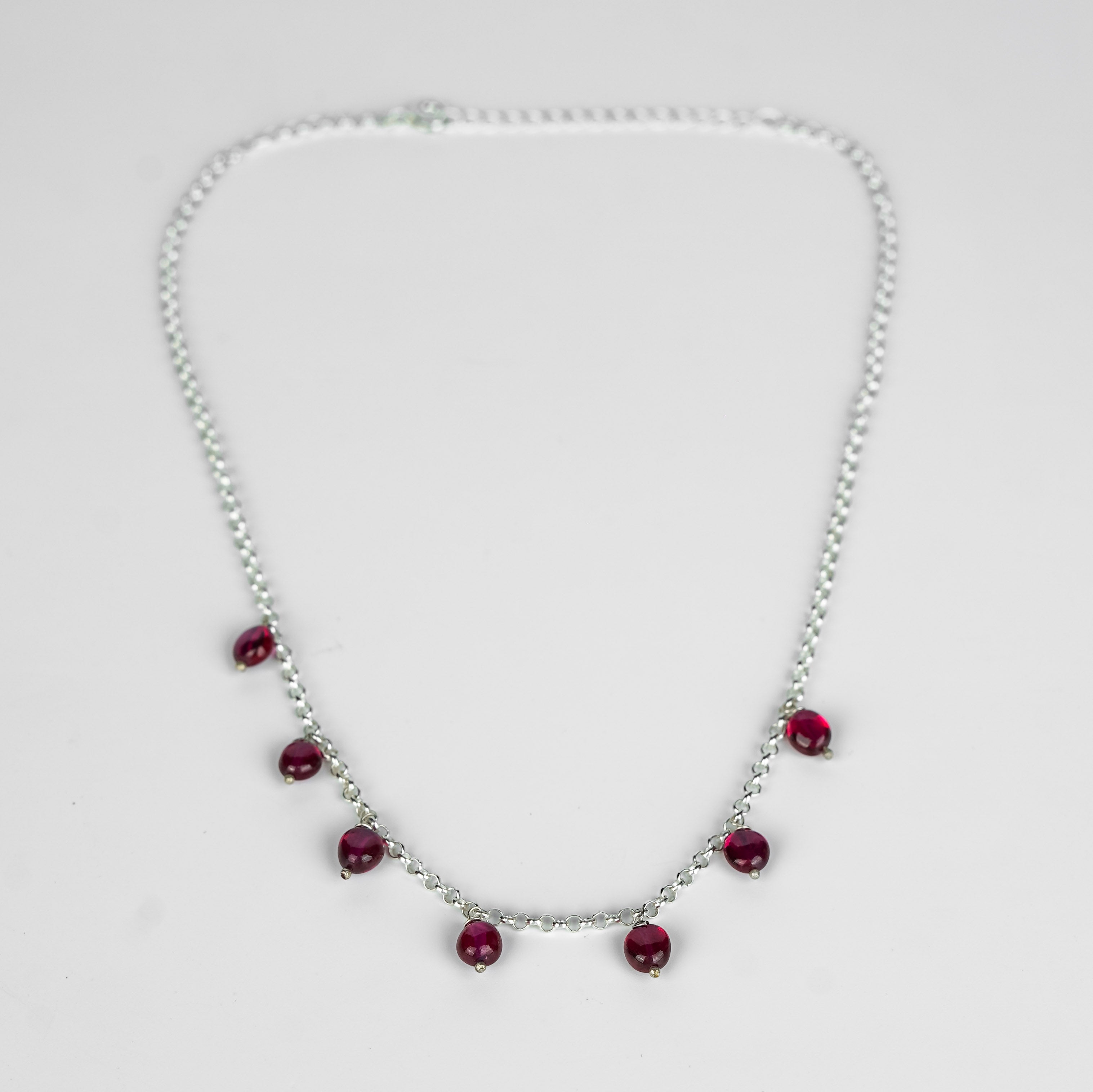 Close-up of Silver Ruby Chain with red gemstone accents, sterling silver jewelry for women