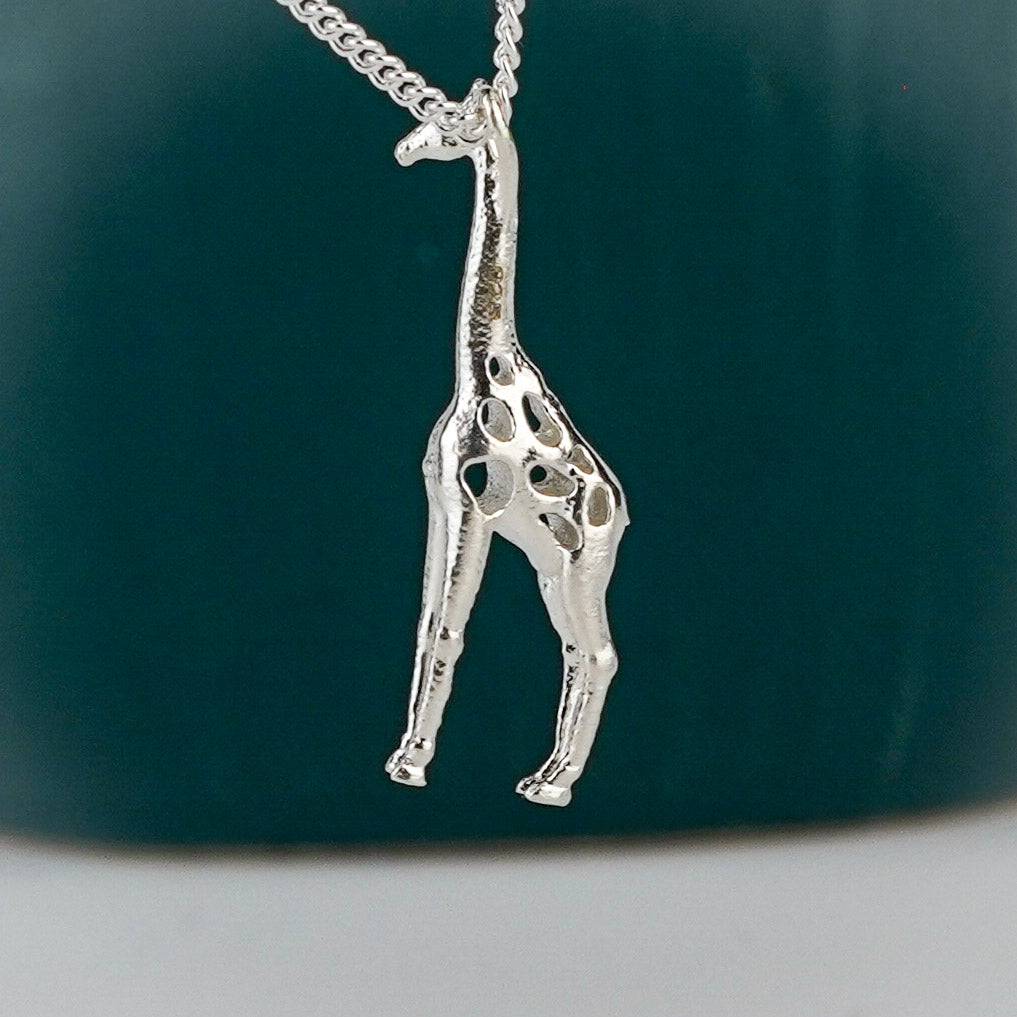 Close-up of silver giraffe pendant jewelry