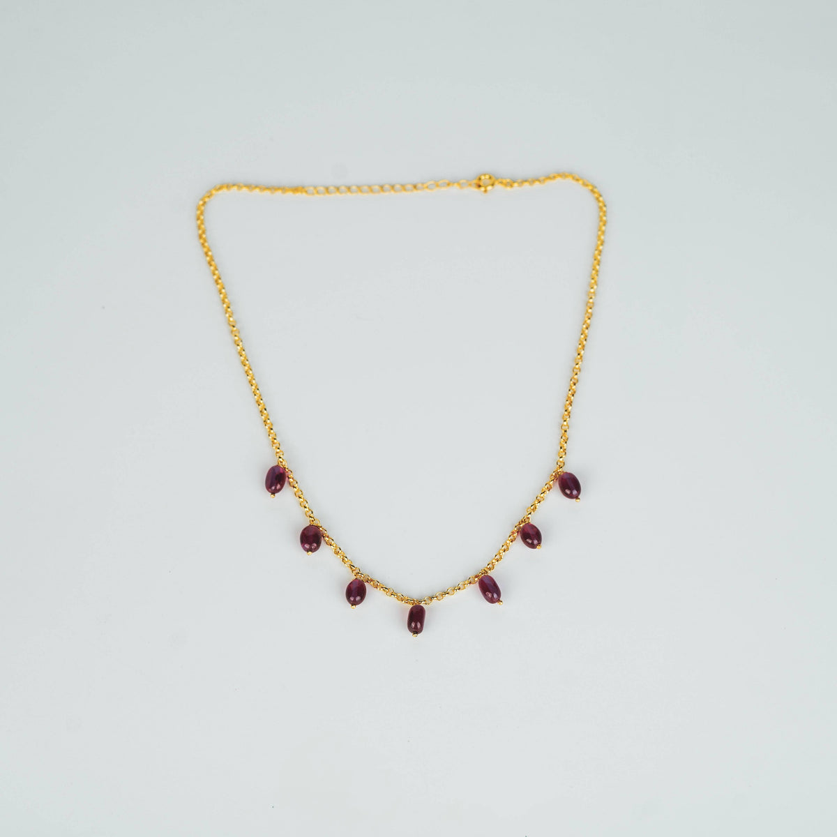 Gold chain with ruby beads
