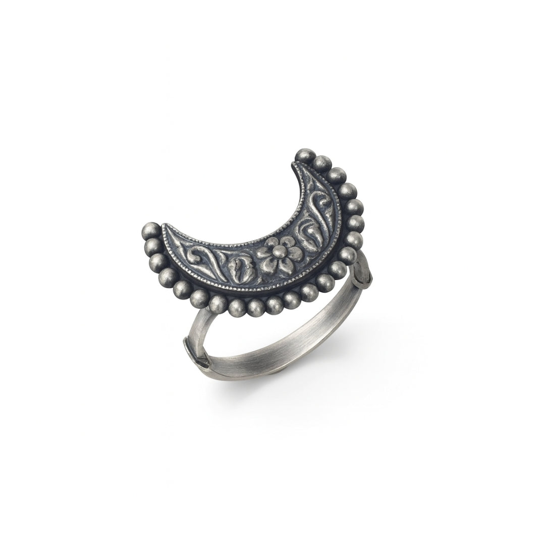 Silver crescent moon ring with floral and swirl engravings, handcrafted jewelry