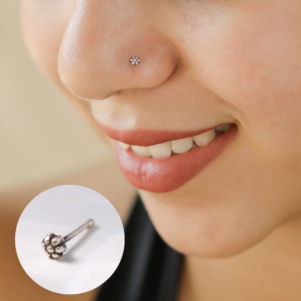 Nose pin worn on nose with floral design