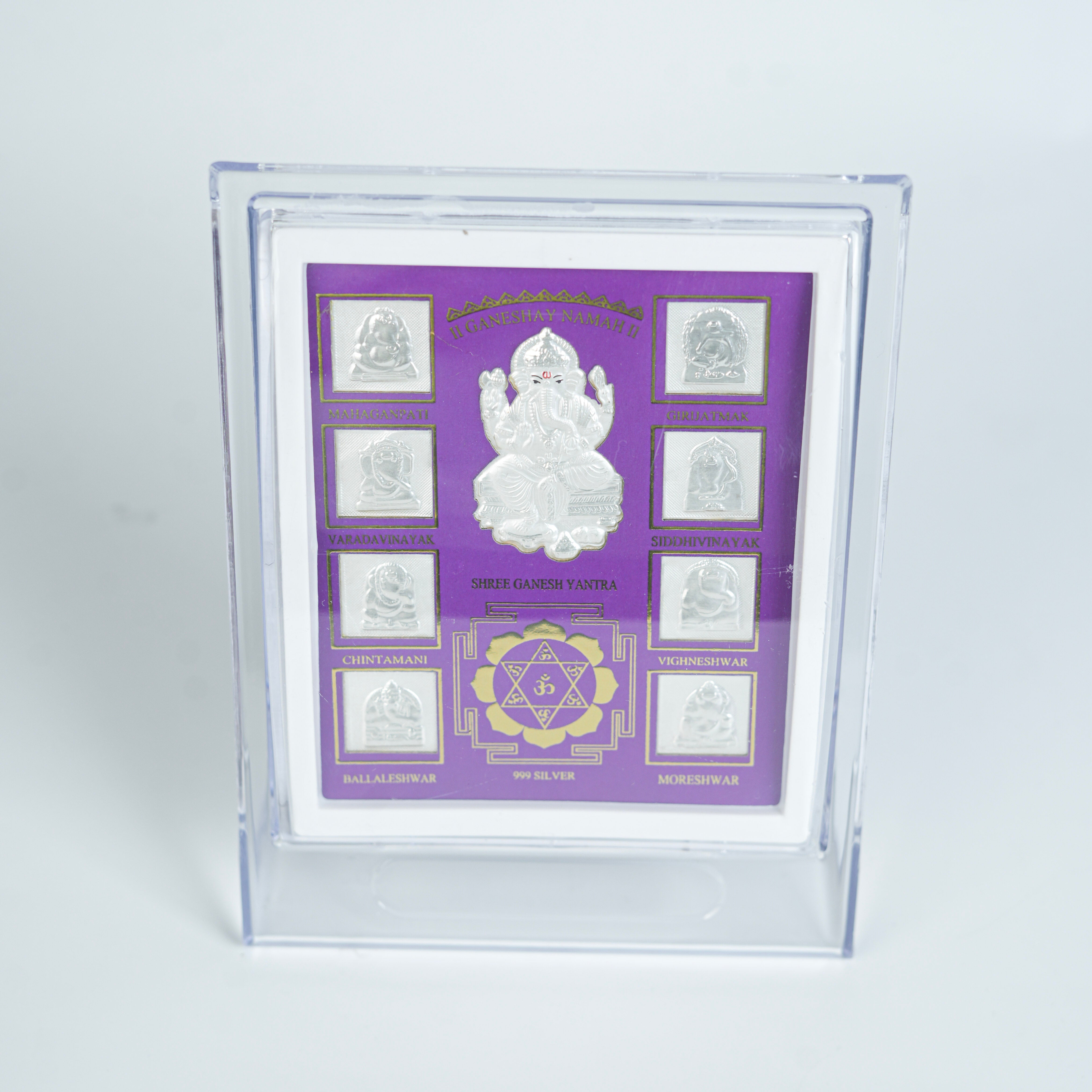 Close-up of silver Ganesh Yantra frame with purple background and intricate design