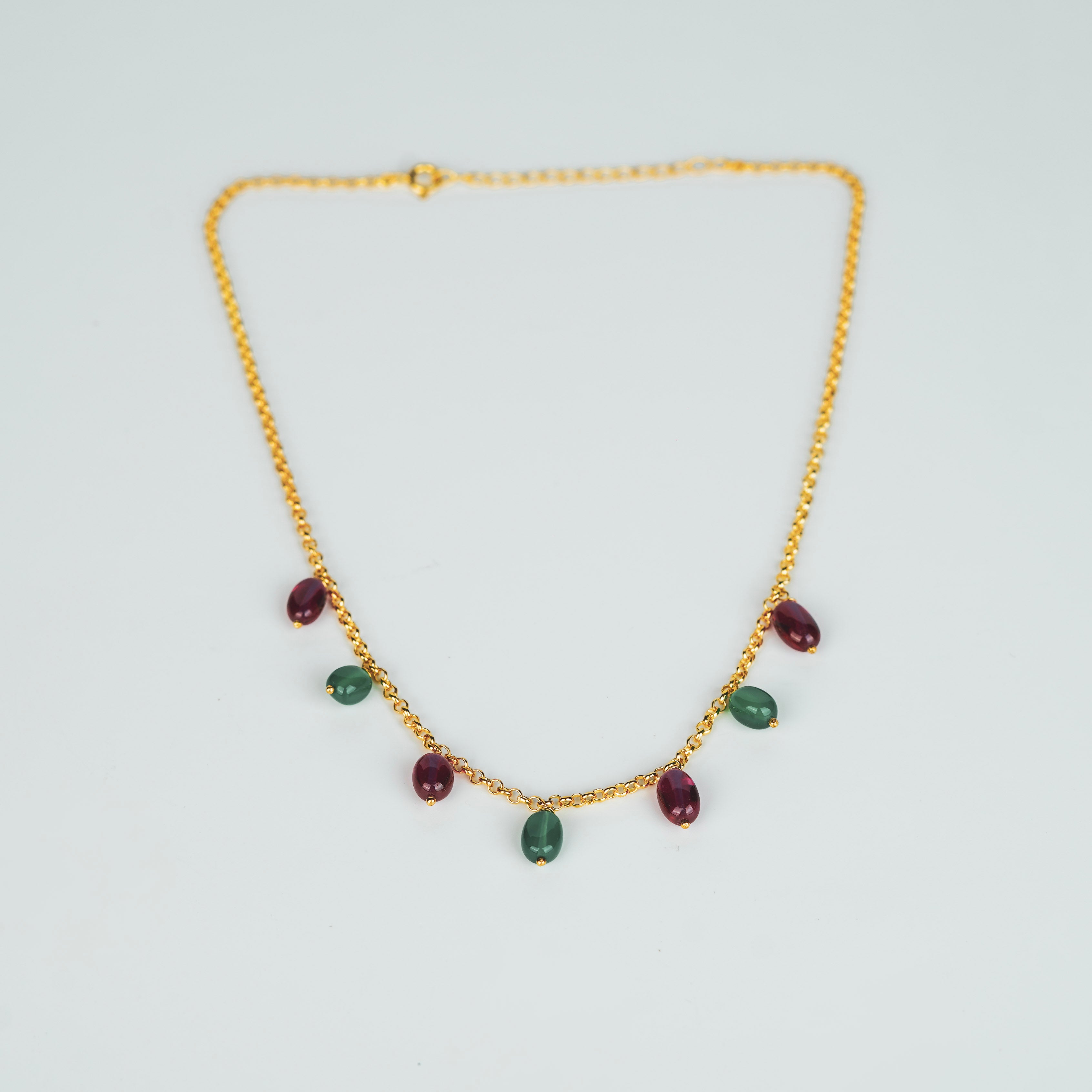Gold chain with red and green gemstones for jewelry