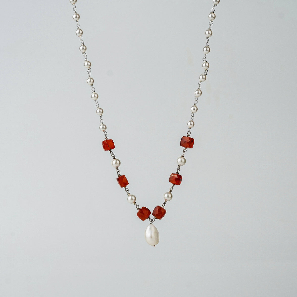 Angled side view of Pearl Ganthan Necklace with stones
