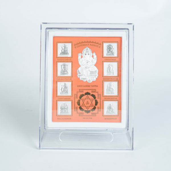 Close-up of silver Ganesh Yantra frame with detailed design and orange background