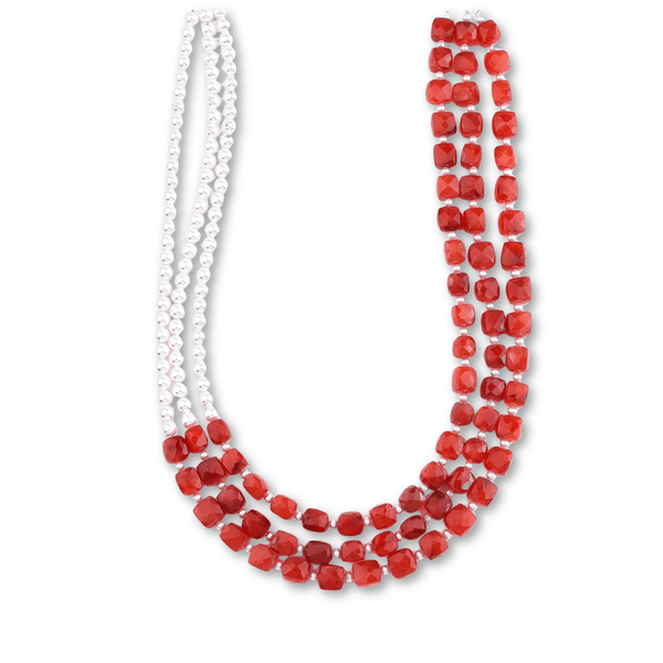 White pearl necklace with red faceted beads