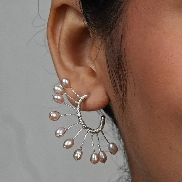 Model wearing Rice Pearl Snowflake Hoops in 92.5 sterling silver for an elegant, handcrafted jewellery look
