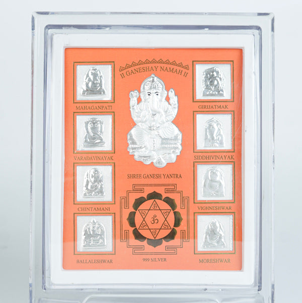 Close-up of silver Ganesh Yantra frame with orange background