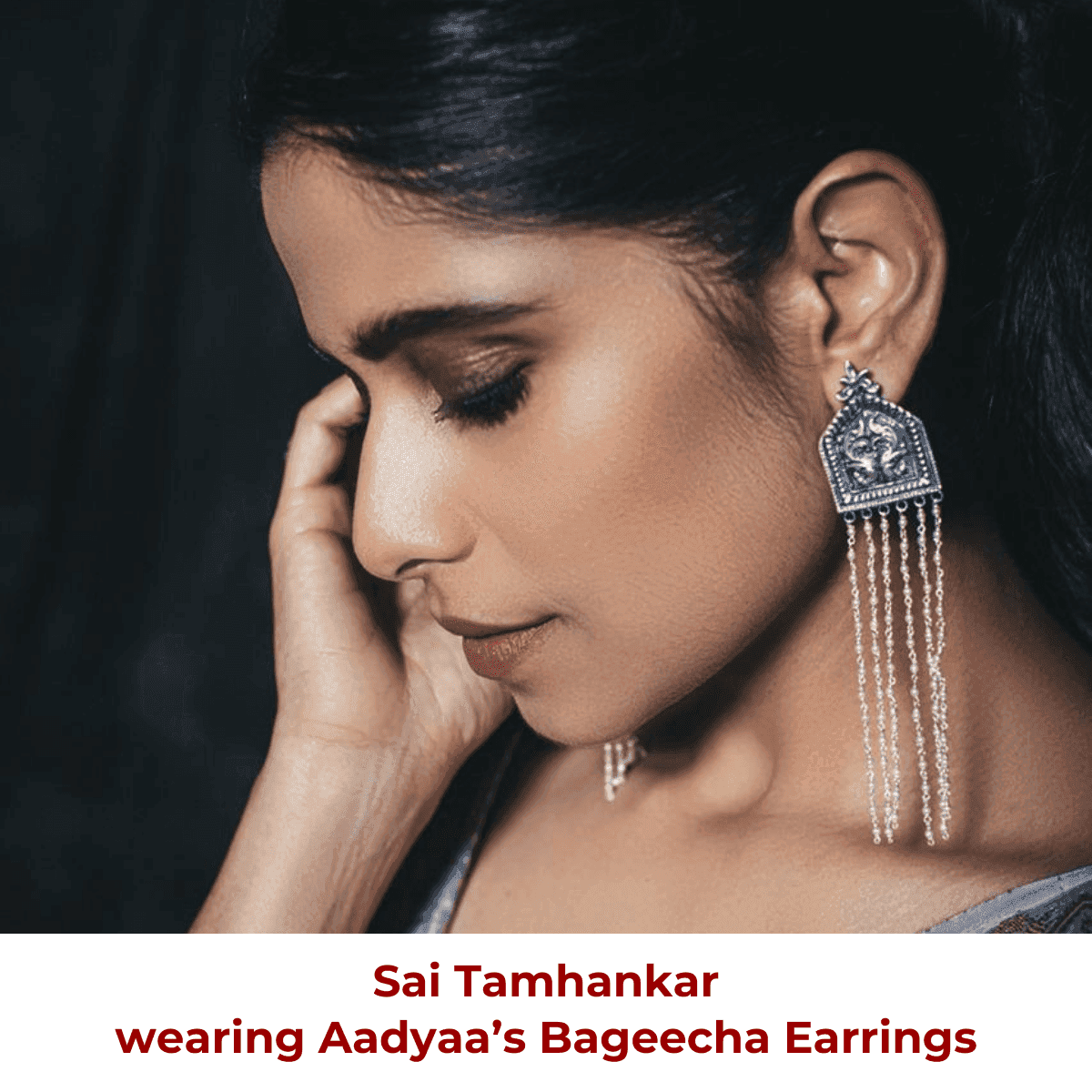 a woman is wearing a pair of earrings
