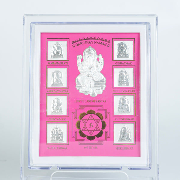 Close-up of silver Ganesh Yantra in pink frame