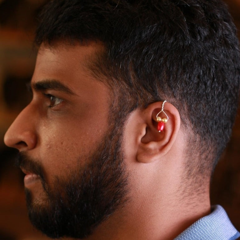 a close up of a person wearing a earring