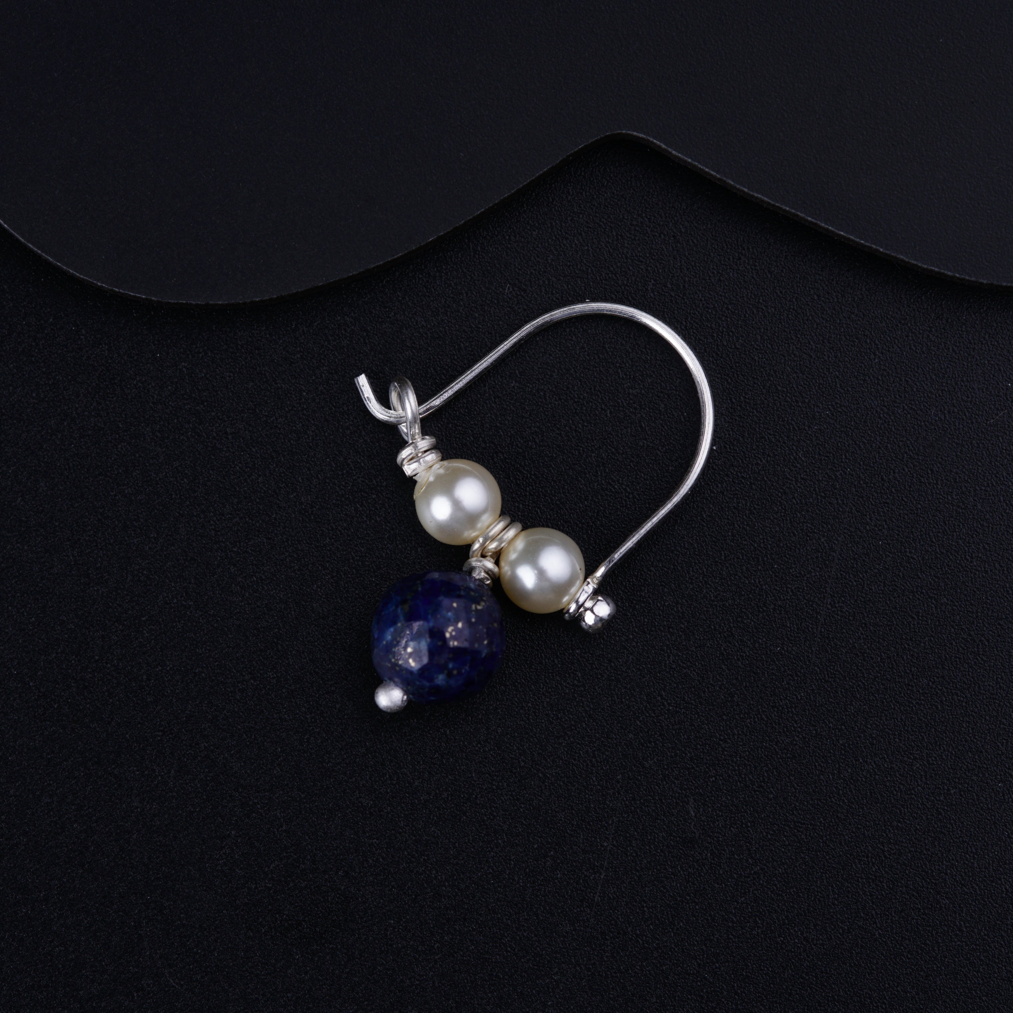 a pair of earrings with pearls and lapis