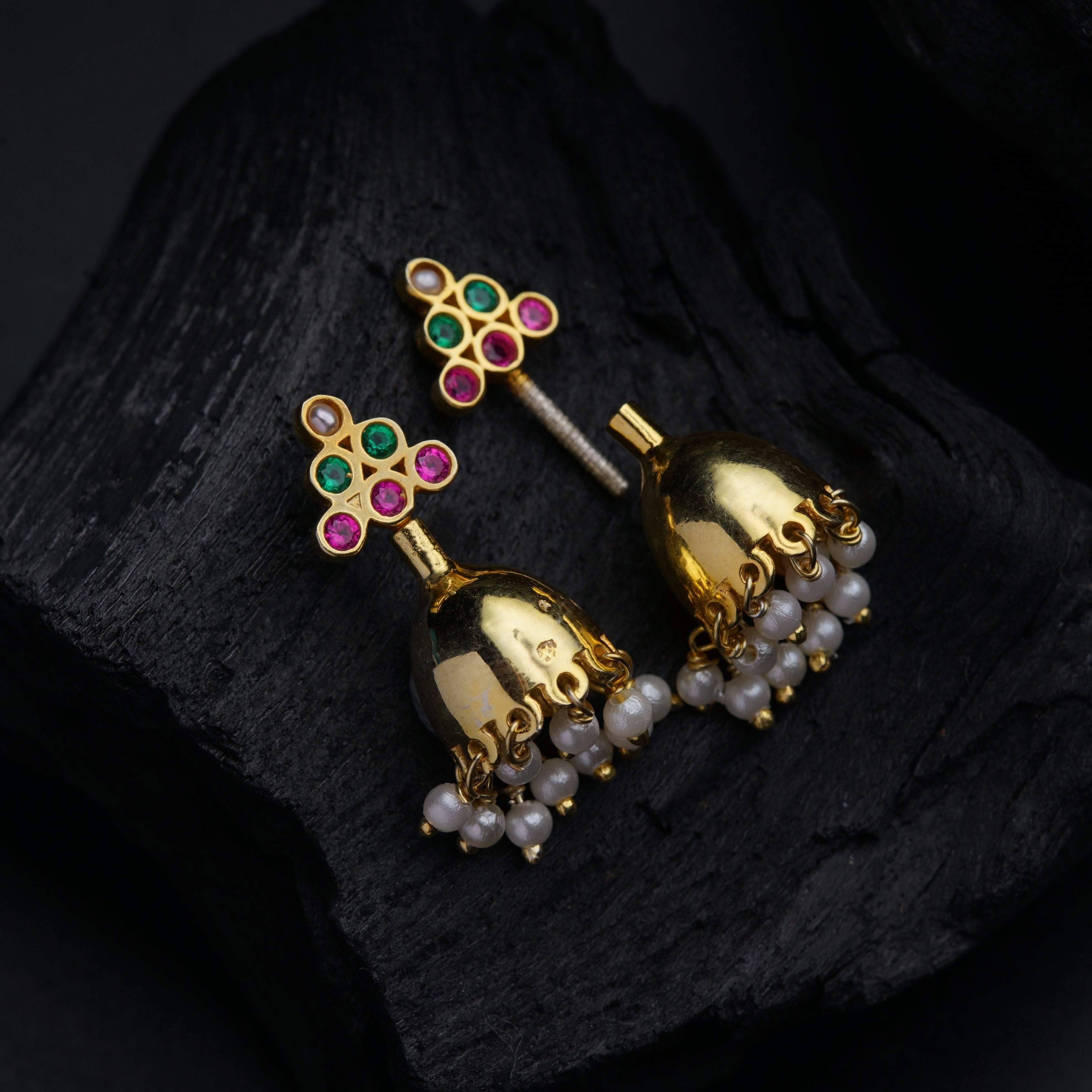 a pair of gold bells with colorful stones