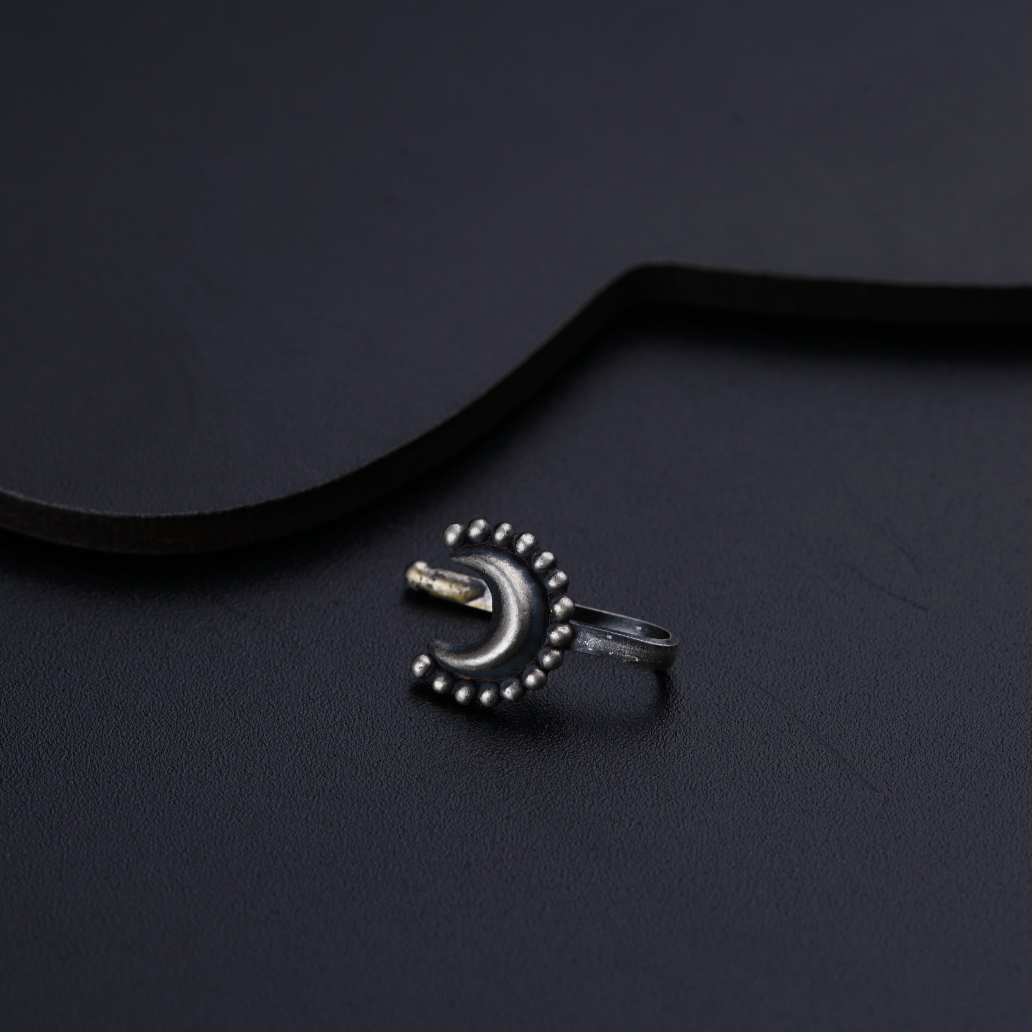 a ring sitting on top of a black surface