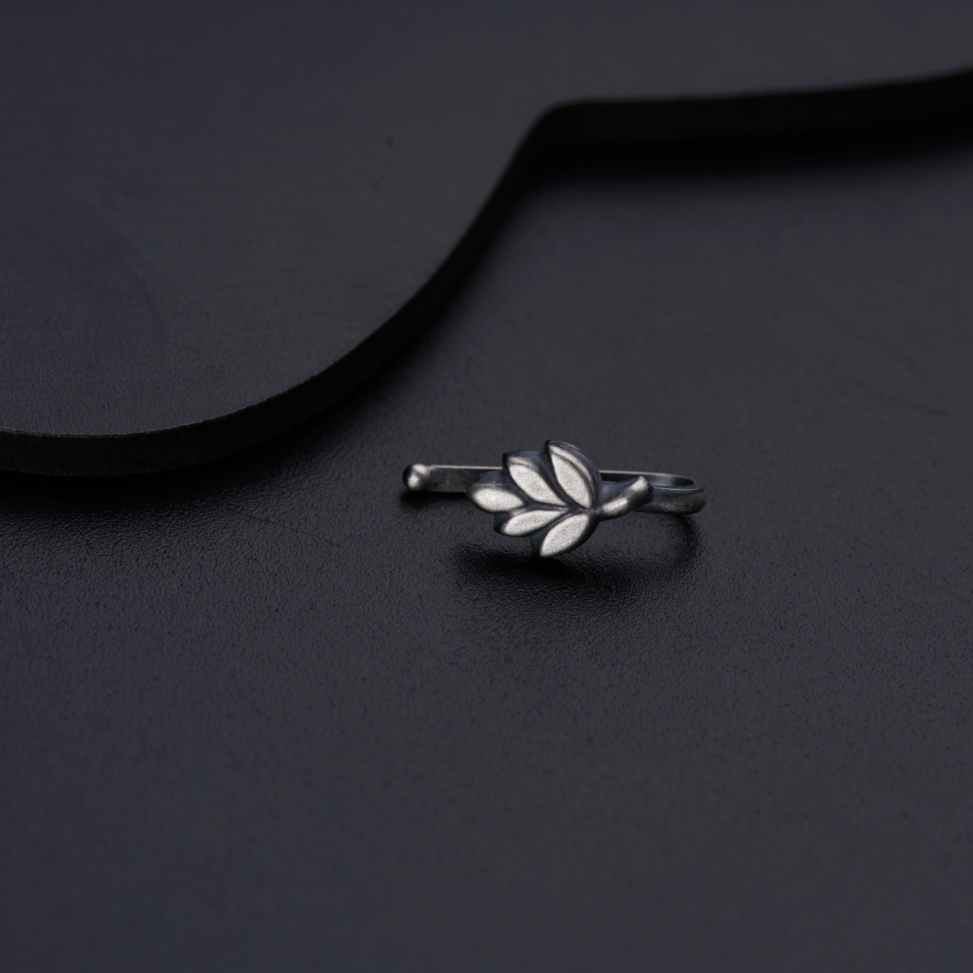 a close up of a ring on a black surface
