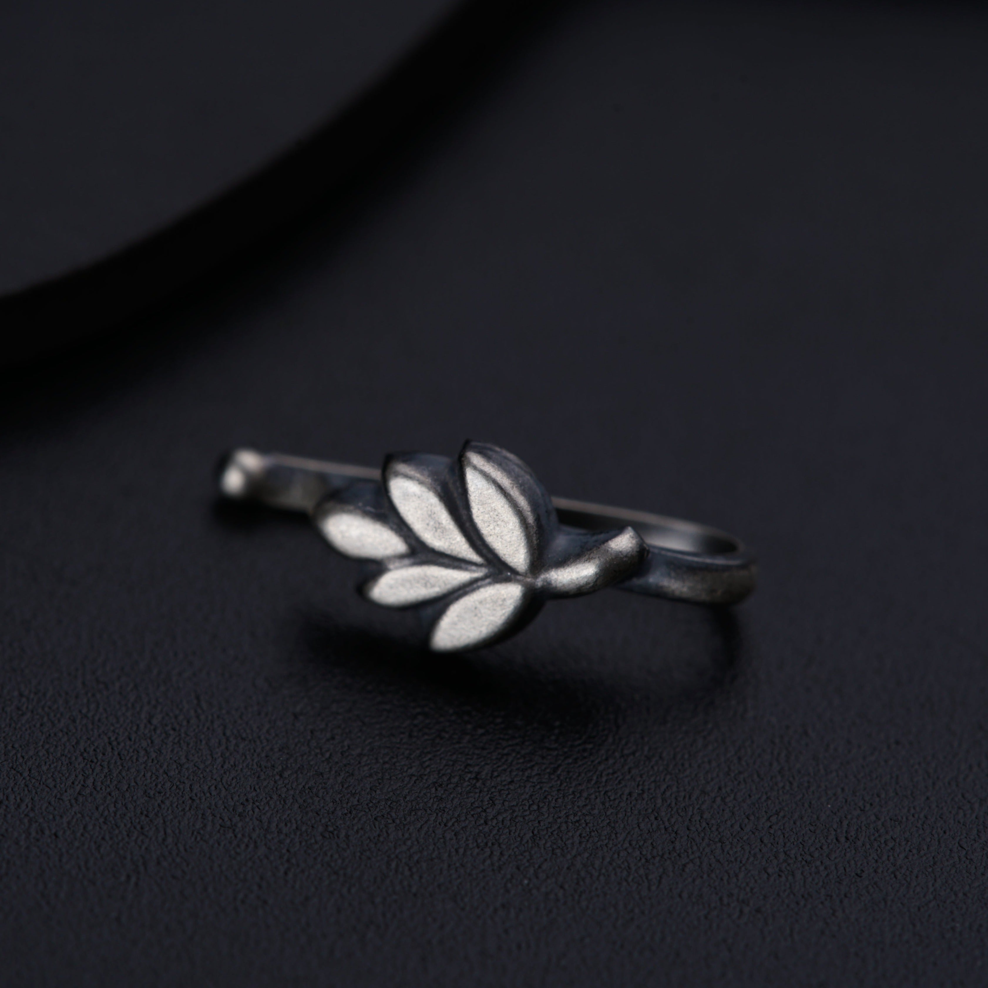 a close up of a ring on a black surface