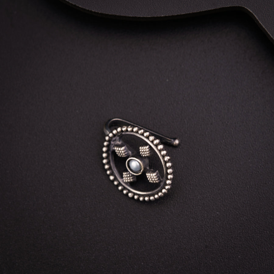 a close up of a metal object on a black surface