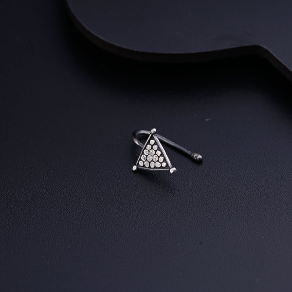 a pair of earrings sitting on top of a black surface