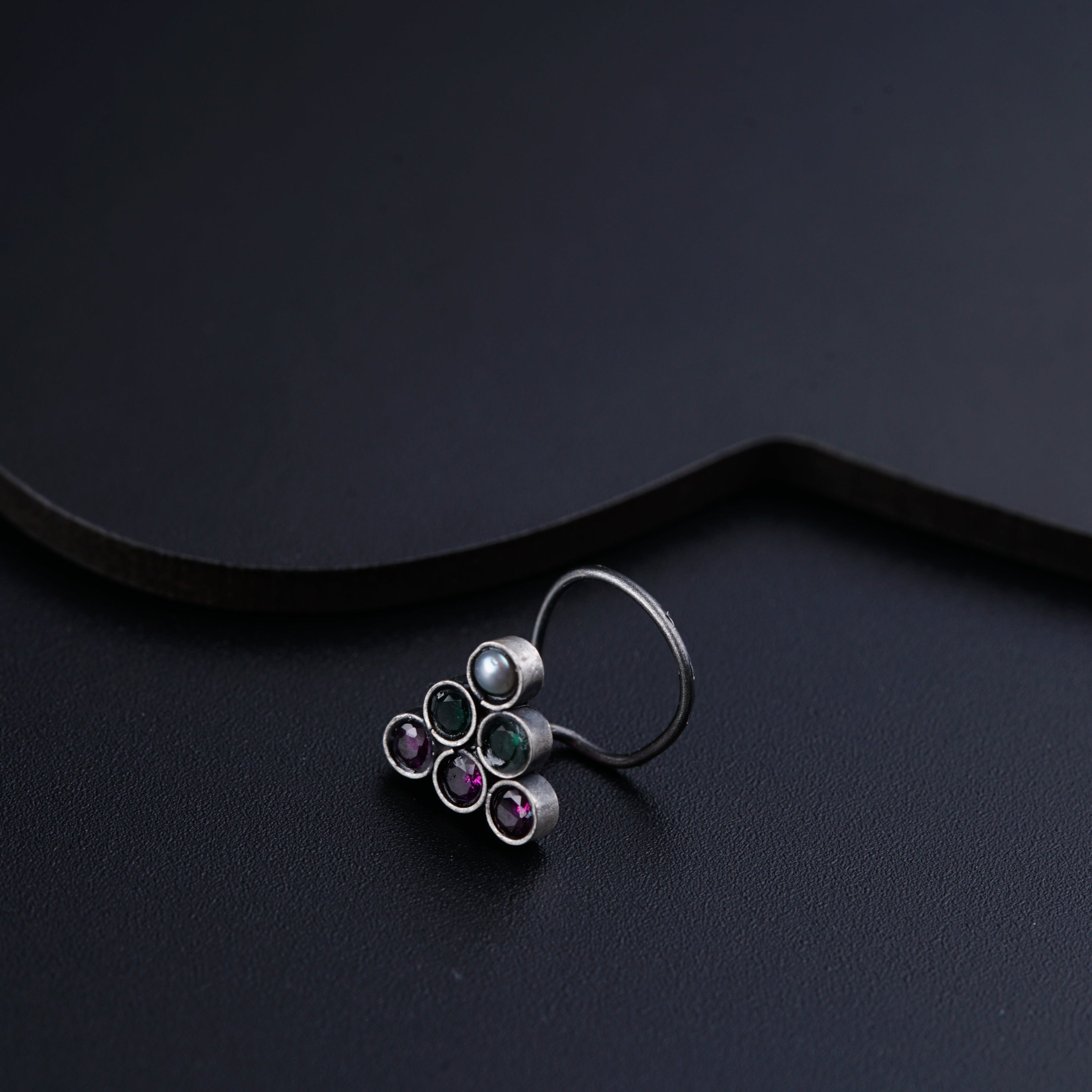 a close up of a ring on a black surface