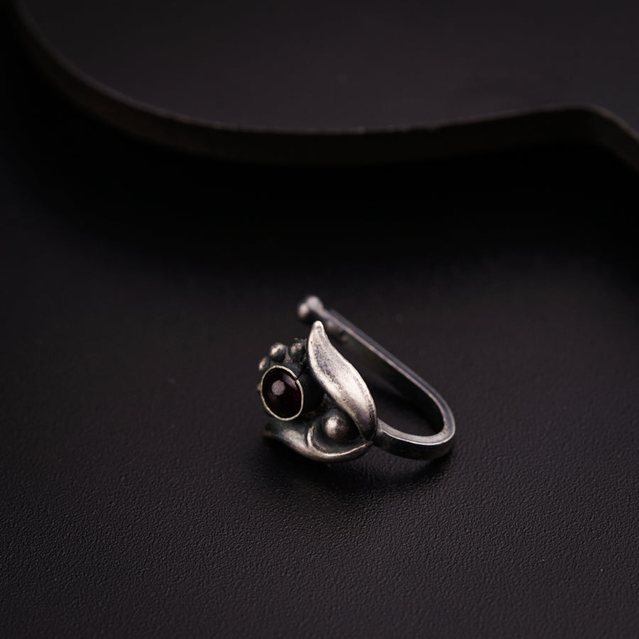a ring sitting on top of a black surface