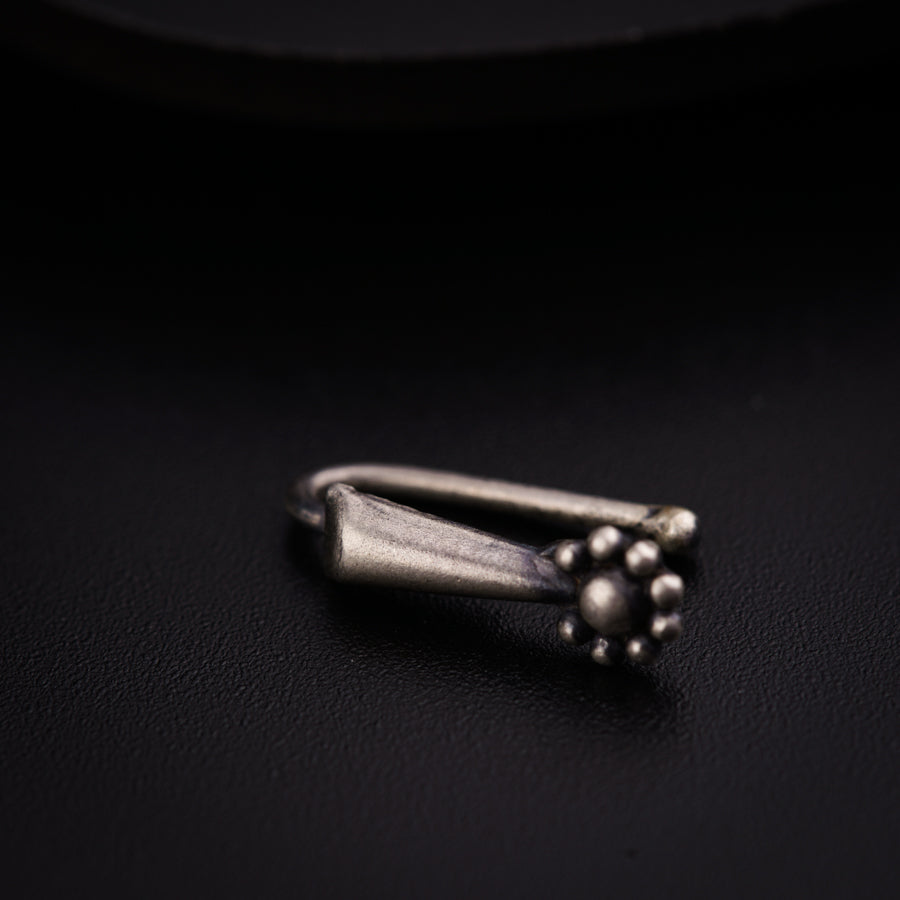 a close up of a metal object on a black surface