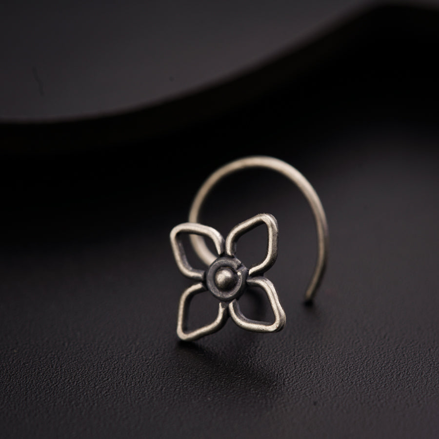 a close up of a ring with a flower on it