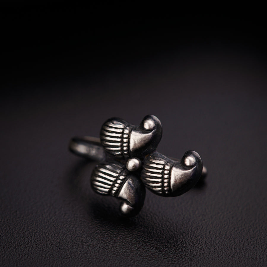 a pair of silver rings sitting on top of a black surface